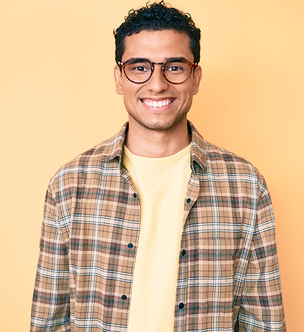 Hispanic man with glasses smiling
