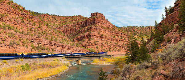 Train going over bridge in a canyon