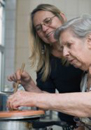 daughter  helps mother in kitchen