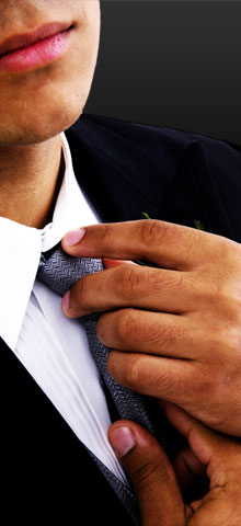 man adjusting tie