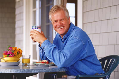 Man eating breakfast on porch