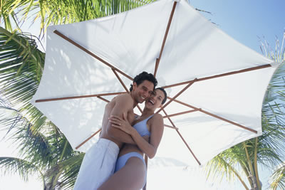 couple under beach umbrella