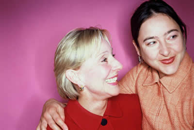 2 women (arm round shoulder, smiling)