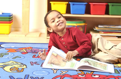 Boy reading happily in school