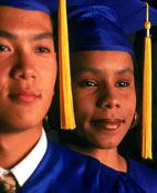 Photo of two faces, a man and a woman, wearing graduation caps and gowns. 