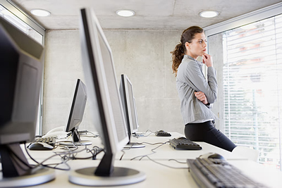 Woman Studying Charts & Computers